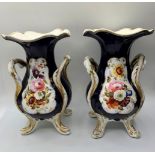 A pair of Daniel four footed vases with floral cartouche, 19cms tall