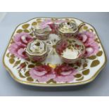 An interesting miniature set of teapot, sugar box, bowl and creamer on a Ribbon & wreath shape plate