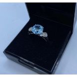 Silver Stone Set Ring with Aquamarine to Centre and Having Four Small Diamonds to Each Shoulder. 925