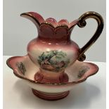 A Staffordshire water jug and bowl, nicely decorated and in a coral colour