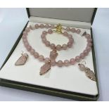 A Necklace, Bracelet and Earrings set of Rose Quartz round Beads and arrow heads in a presentation