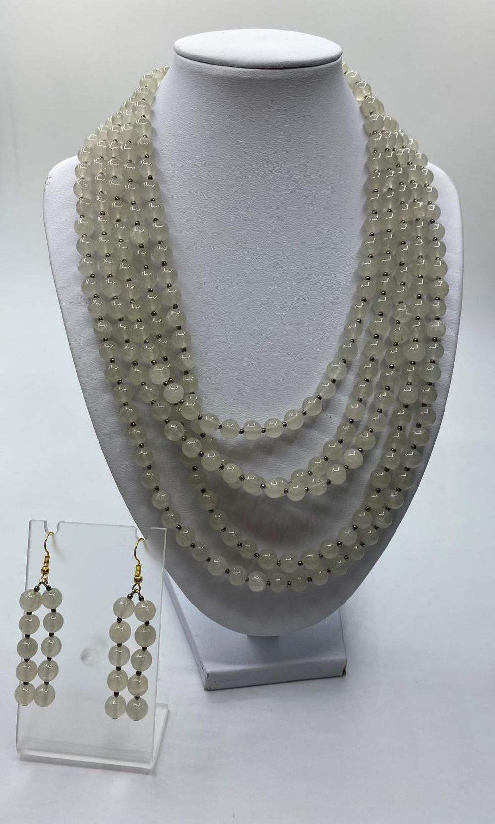 A five row Chinese pale jade necklace (length 45-58cm) and matching earrings. Total weight 202g.