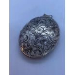 Large Vintage Silver Locket. Oval Shape with Foliage Scrollwork to Cover and Plain Silver Back.