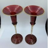 A pair of Blown Cranberry Glass Candlesticks with glass and gold stems, 25cm tall (2)