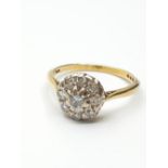 Stone set 18ct Gold Ring having a Diamond Centre stone with an 8 diamond circular surround,