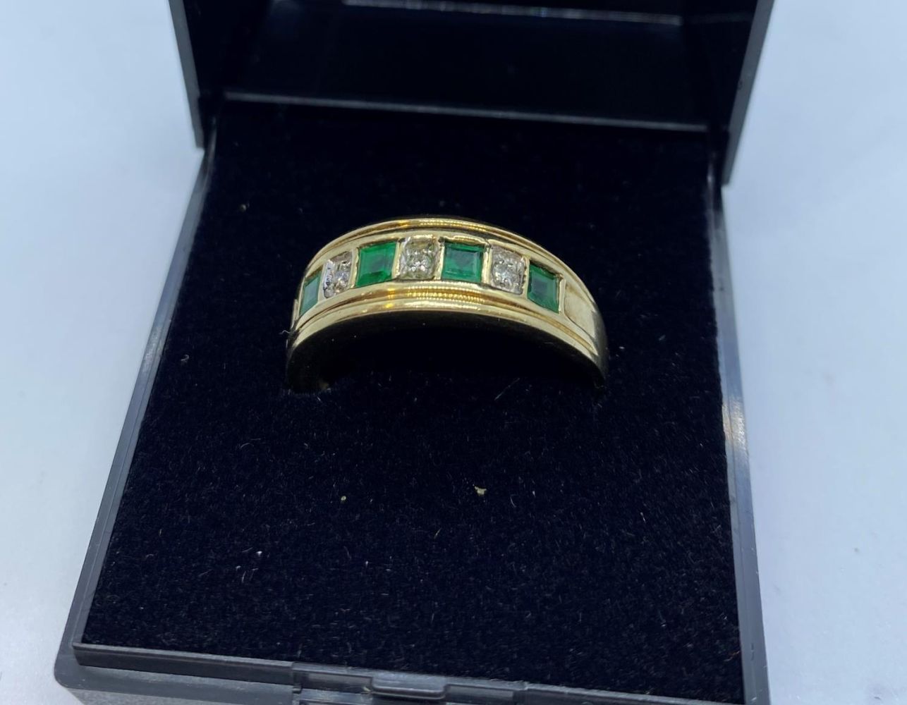 Stone Set Gold Ring Having Emeralds and Diamonds to Top in a Half Eternity Type Setting. 9 Carat