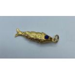 18ct gold flexible Fish Pendant, weight 6.8g and 4cm long approx