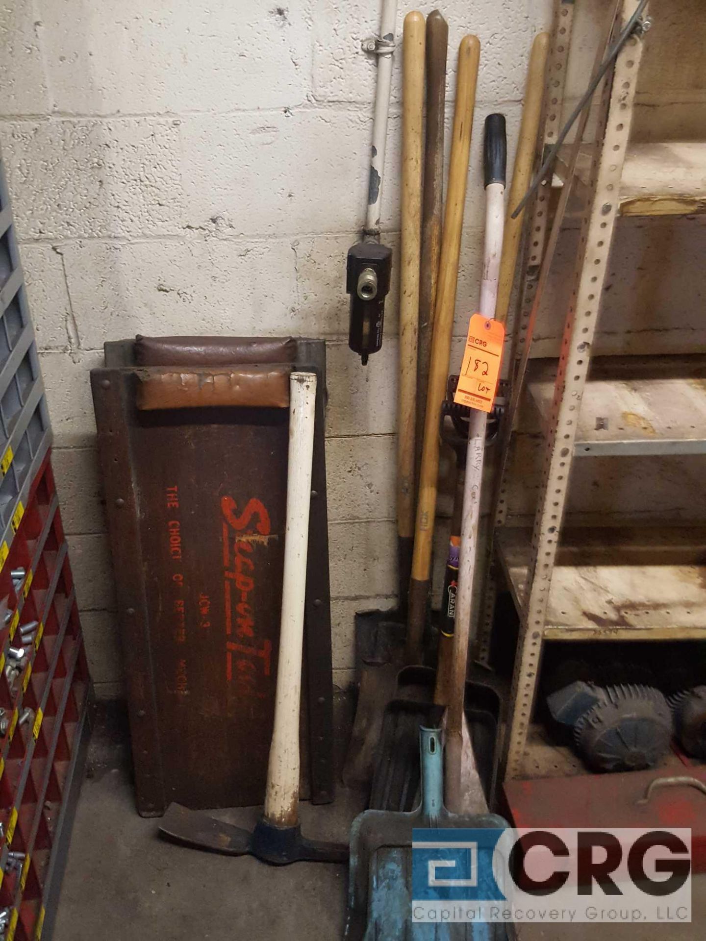 Lot of assorted yard and garage tools , including shovels, pick axe, creepers, etc.