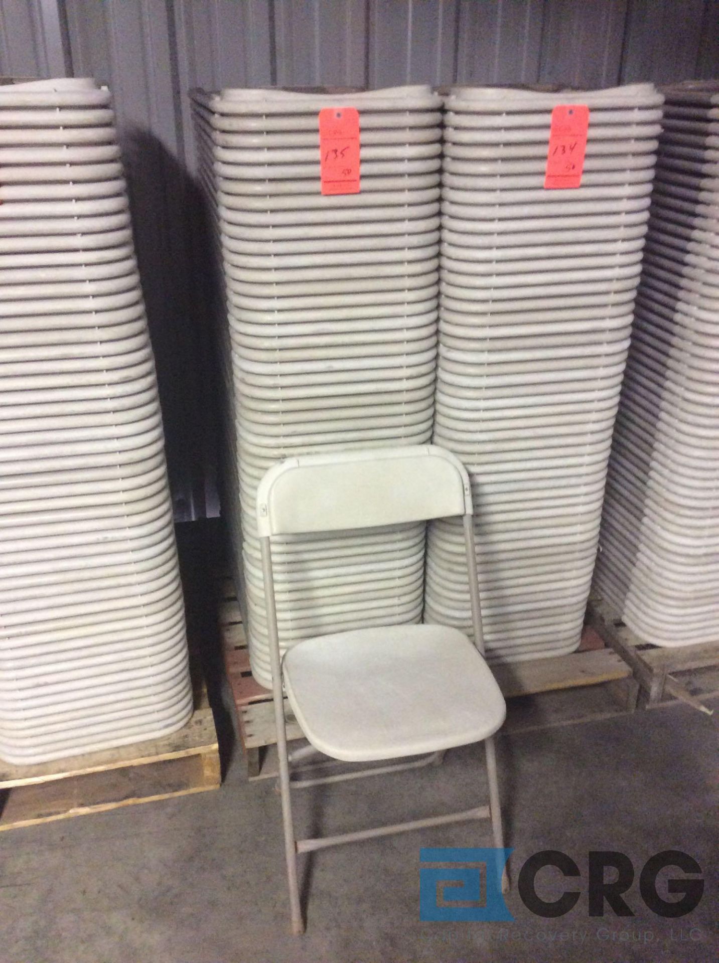 Lot of (50) beige metal / plastic folding stack chairs