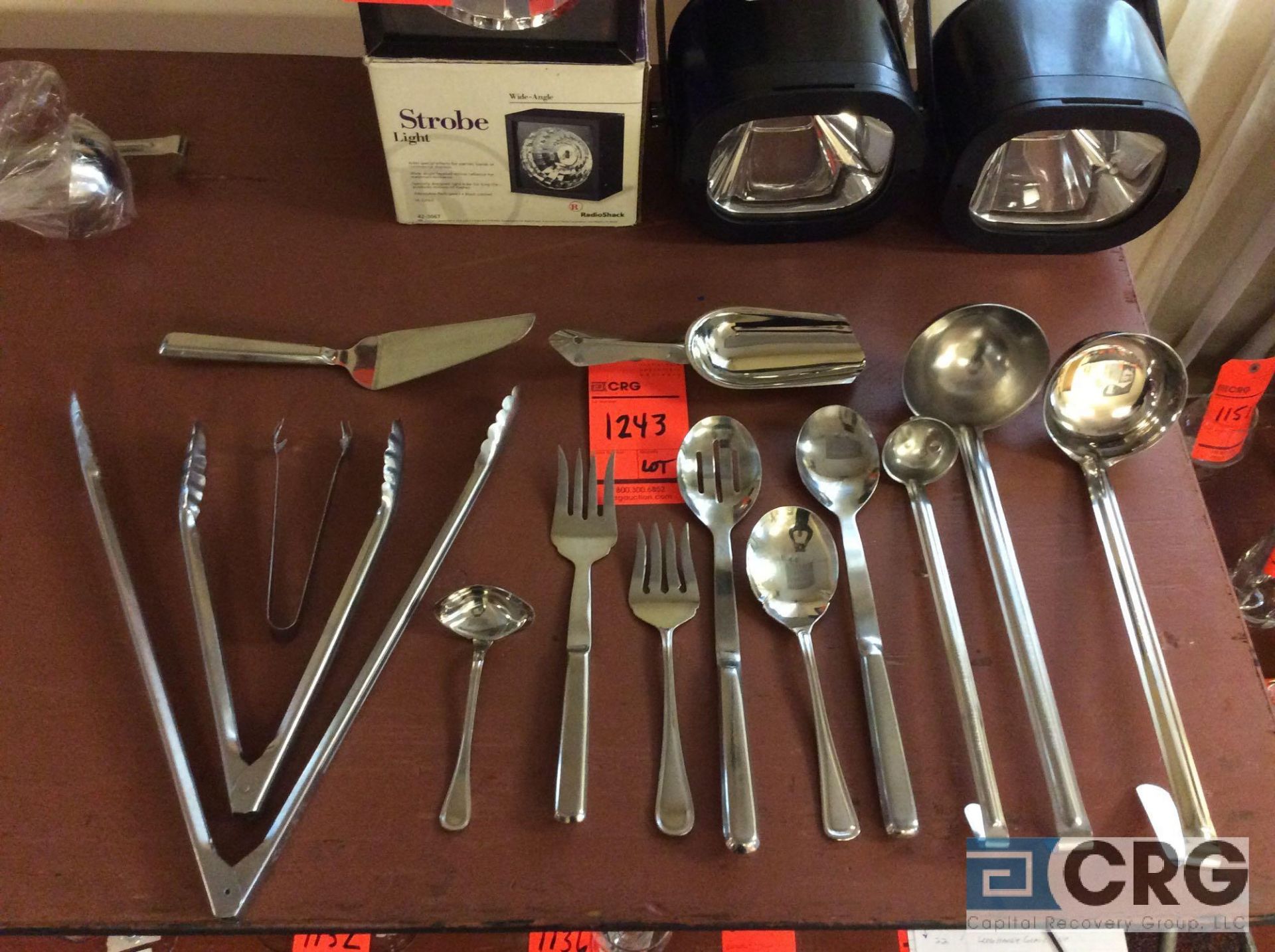 Lot of stainless steel serving pieces including (30) gravy ladles, (22) long handle gravy ladles, (