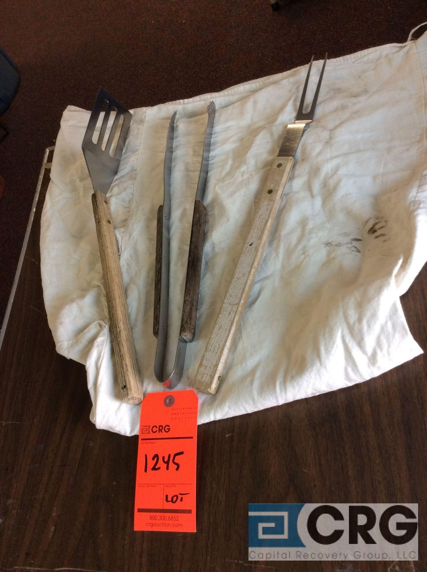 Lot of barbecue serving utensils including (20) forks, (17) spatulas, and (11) tongs