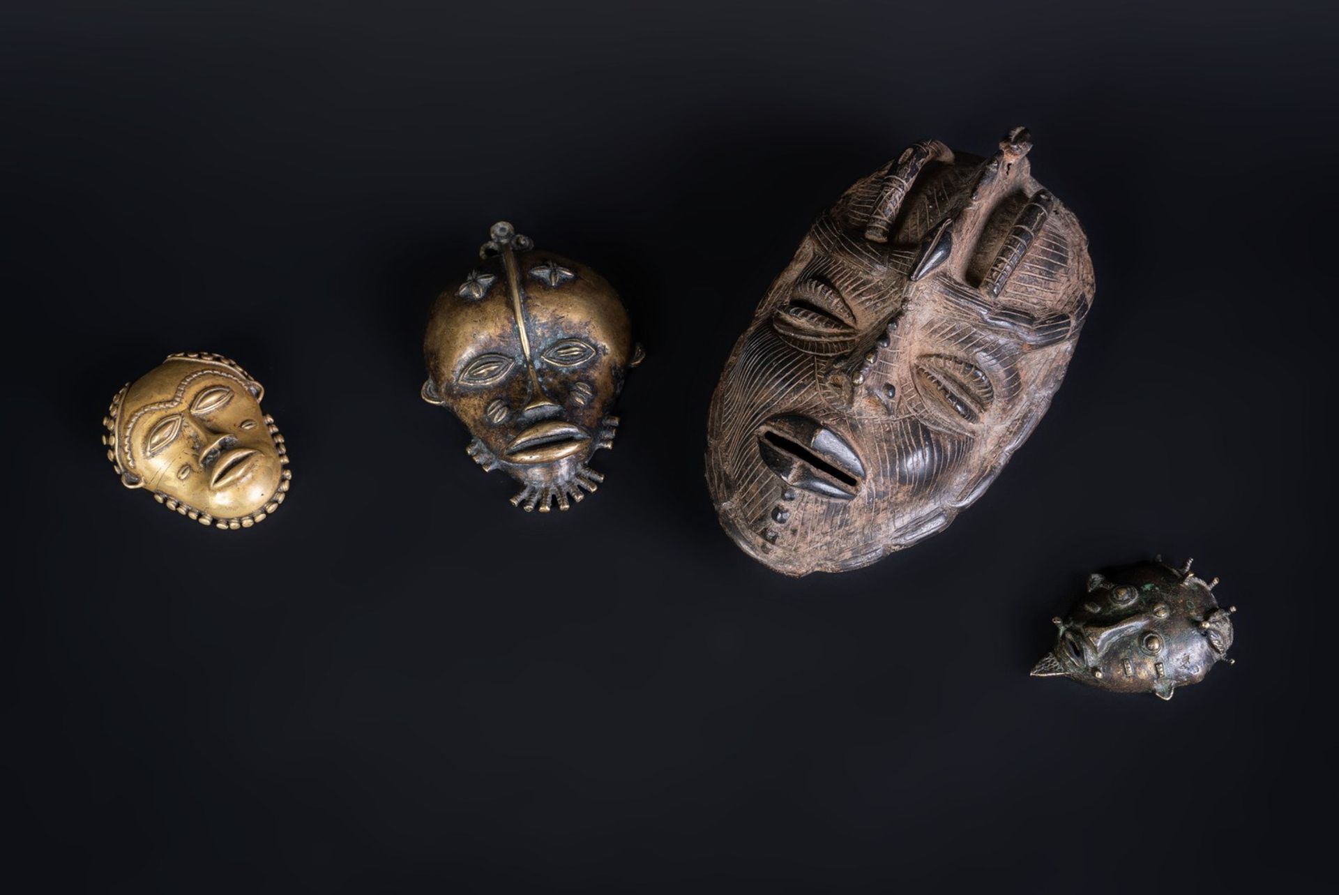 Arte africana Four metal masksSub-Saharan Africa.