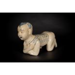 Arte Cinese A large cizhou headrest moulded in the shape of a crouched childChina, Qing dynasty, 19