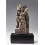 Arte Indiana A grey schist plaque carved with a lady beautifying herselfAncient region of Gandhara,