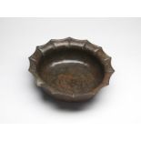 Arte Islamica A fine large bronze stellar basin engraved with sphinx over latticed background Khora