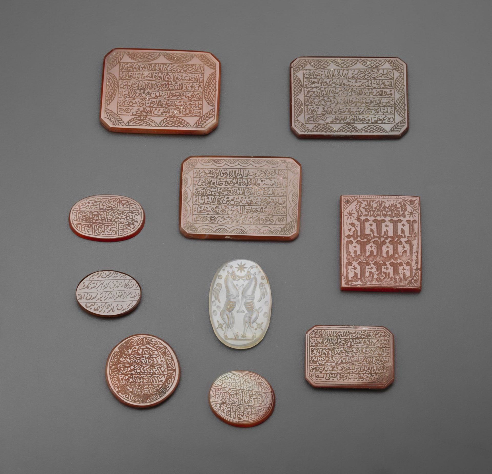 Arte Islamica A group of nine carnelian seals and one rock crystal plaque engraved with animals Per - Image 3 of 3