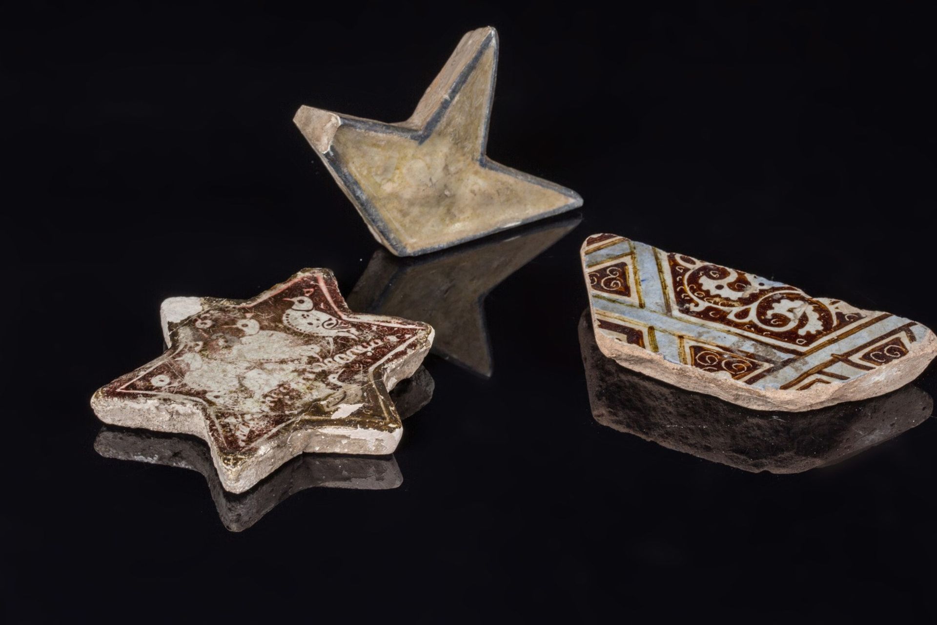 Arte Islamica A lot composed of three Islamic star tile fragmentsIran, 12th - 14th century .
