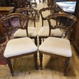 A set of four early Victorian rosewood dining chairs, the backs carved acanthus leaves, on
