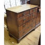 A George III chest, veneered in walnut, having two short and three graduated long drawers, on