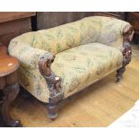 An unusual Victorian settee, of small proportions, the arms carved scantily clad figures, on