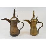 An Arabian brass dallah coffee pot, 31 cm high, and another similar (2)