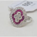 A large platinum Victorian style ruby and diamond cluster ring, of shaped oval form, approx. ring