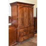 A Victorian mahogany linen press, having a pair of panel doors flanked by columns, above two short