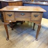 An oak lowboy, having three drawers, on cabriole legs with pad feet, 82.5 cm wide Report by RB Top