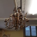 A gilt brass twelve light chandelier, fitted for electricity (needs re-wiring), 74 cm wide