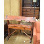 A Victorian country house pine saddle horse, with iron mounts, 122 cm wide One of the ends of the