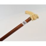 A walking cane, the L shaped walrus ivory handle in the form of a sailor with sulphur glass eyes