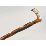 A Swedish folk art walking cane, the shaft profusely carved fish and eels, dated 1891, 78 cm