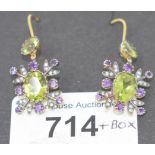 A pair of drop earrings, set peridots, diamonds and amethysts, boxed Report by GH The material the