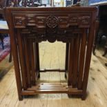 A nest of four Chinese carved hardwood occasional tables, the largest 51 cm wide