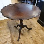 A George III style mahogany tripod table, with a piecrust top, a fluted and reeded vase turned