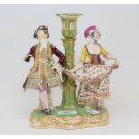 A 19th century porcelain figural candlestick, possibly Derby, some loss, 22.5 cm high