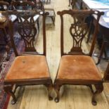 A pair of Colonial 18th century dining chairs, with pierced vase shaped splats, drop in seats and