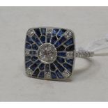An Art Deco style platinum, sapphire and diamond ring, of square form, with a central old cut