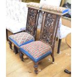 An unusual pair of Victorian rosewood prie dieu/nursing chairs, the pierced backs decorated