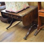 A Regency sofa table, veneered in pollard oak, having two real and two false drawers, on end