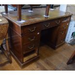 A mahogany pedestal desk, having an arrangement of nine drawers, 122 cm wide