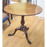 A George III mahogany tripod table, on a birdcage support and baluster turned column, 76 cm diameter