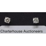 A pair of 18ct white gold and diamond solitaire stud earrings, approx. 0.60ct, boxed