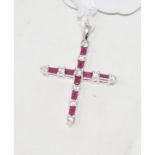 An 18ct white gold, ruby and diamond set cross, the rubies approx. 0.31ct, the diamonds approx. 0.