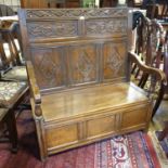 An oak box settle, the back carved lozenges and foliage, 106 cm wide