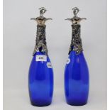 A pair of blue glass decanters, with grape and vine plated mounts, 34 cm high