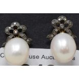 A pair of white pearl drop earrings, with diamond bow tops, boxed Report by GH The measurements