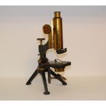 A brass and lacquered brass monocular microscope, J Woolley, Victoria Bridge Manchester, in a