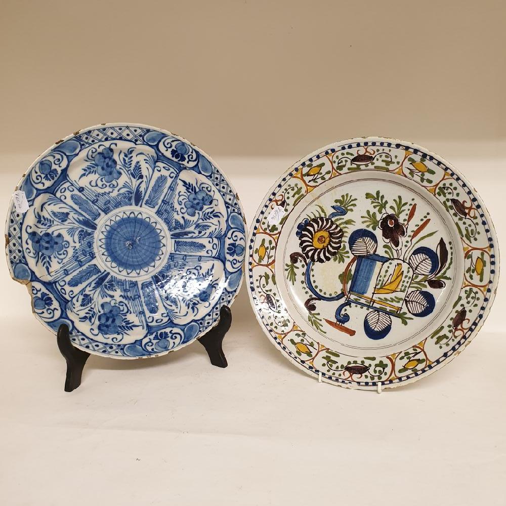 A Dutch delft polychrome plate, decorated flowers, 35 cm diameter, three other chargers, and six - Image 2 of 3