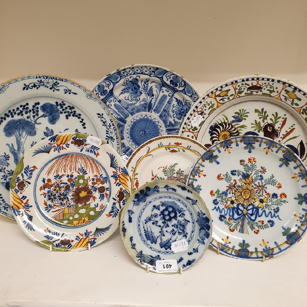 A Dutch delft polychrome plate, decorated flowers, 35 cm diameter, three other chargers, and six